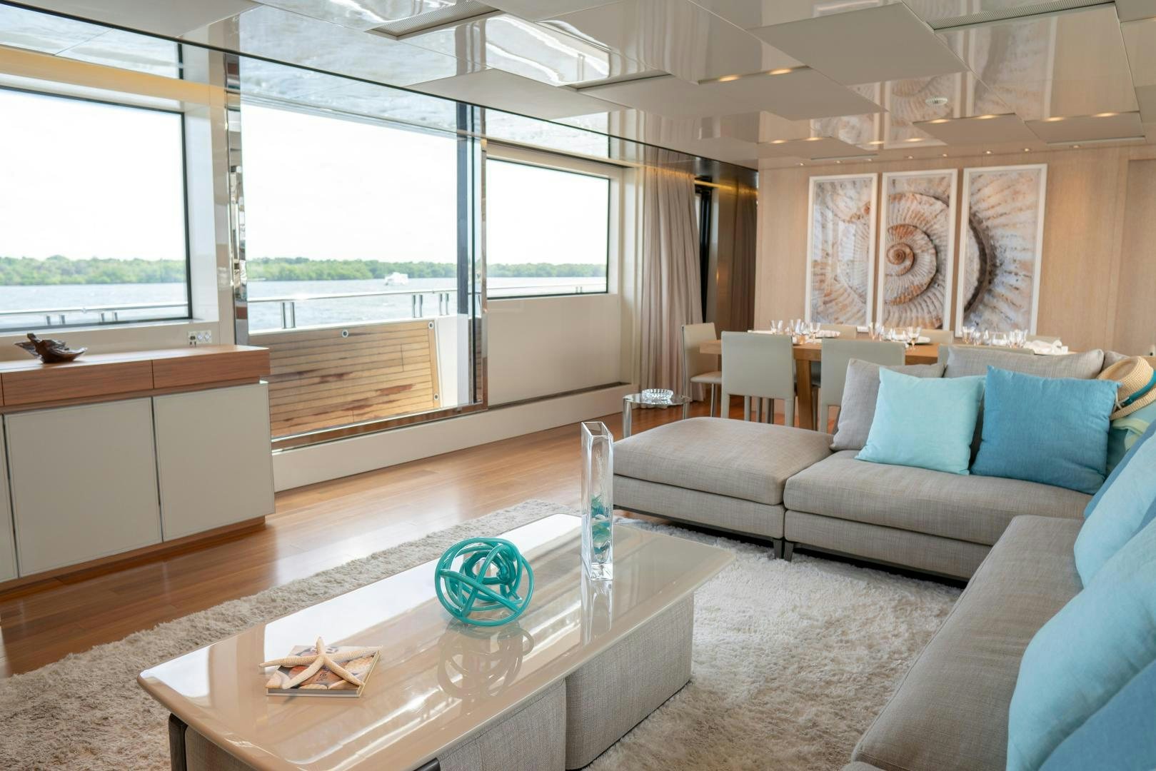 a living room with a couch and a coffee table aboard BODACIOUS Yacht for Sale