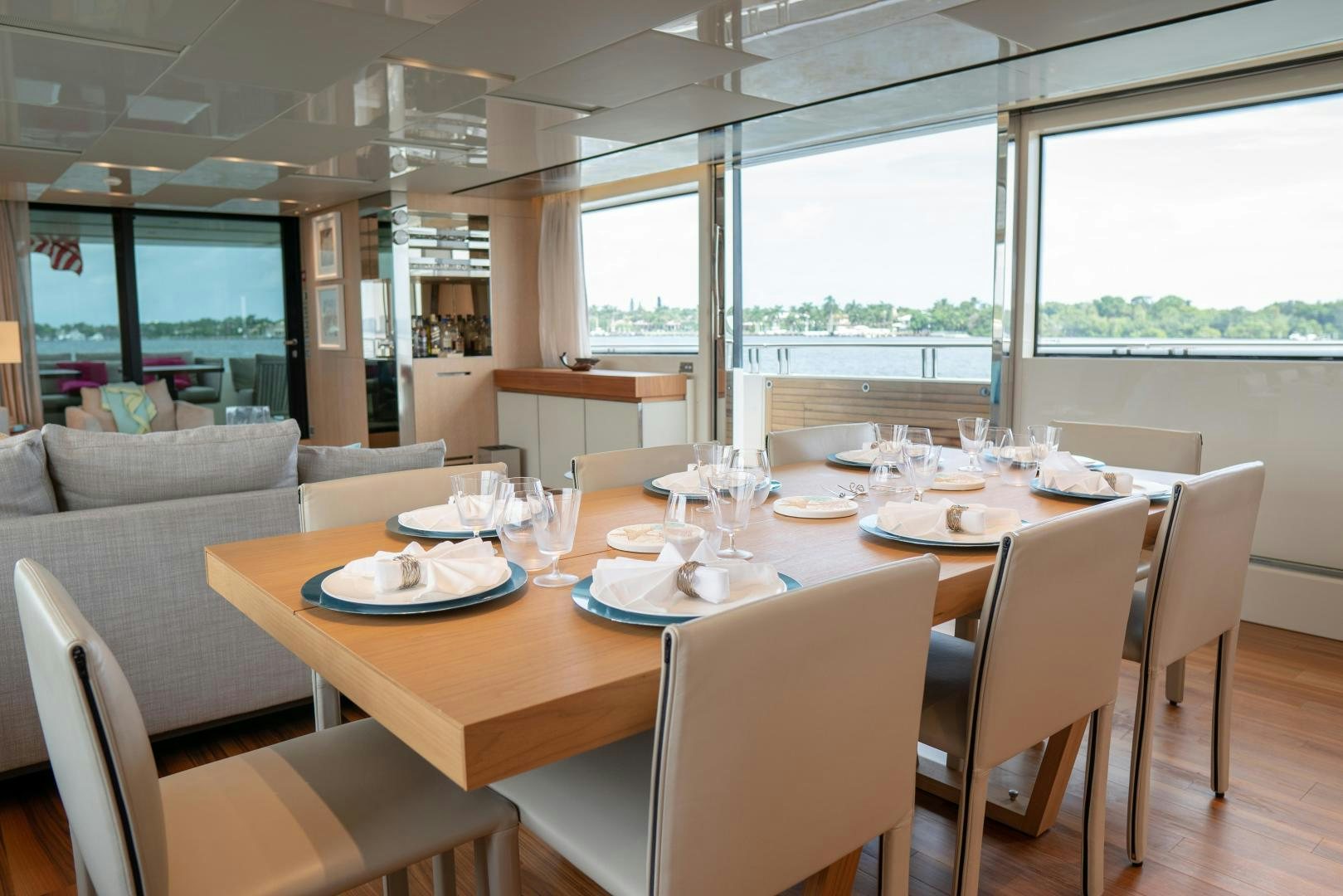 a dining table with plates and glasses aboard BODACIOUS Yacht for Sale