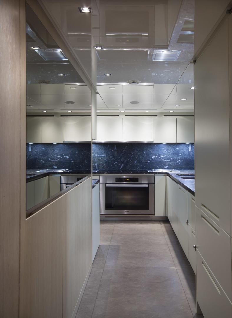 a kitchen with white cabinets aboard BODACIOUS Yacht for Sale