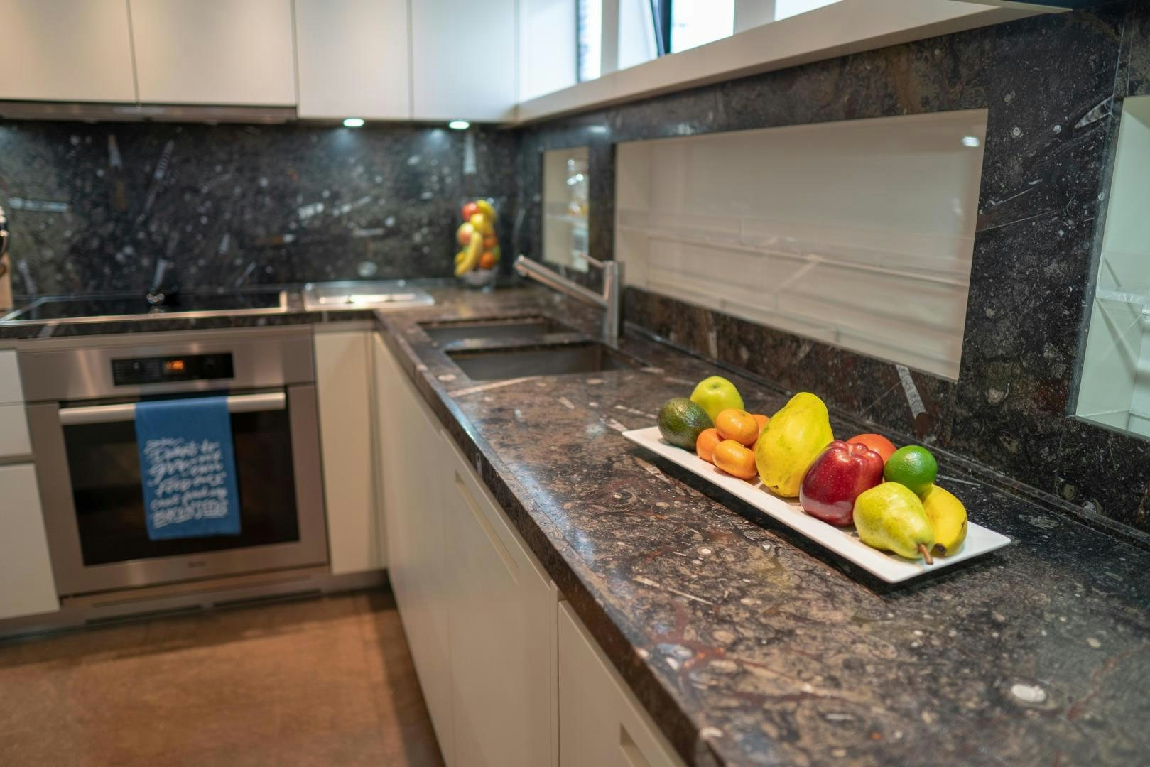 a kitchen with a marble counter top aboard BODACIOUS Yacht for Sale