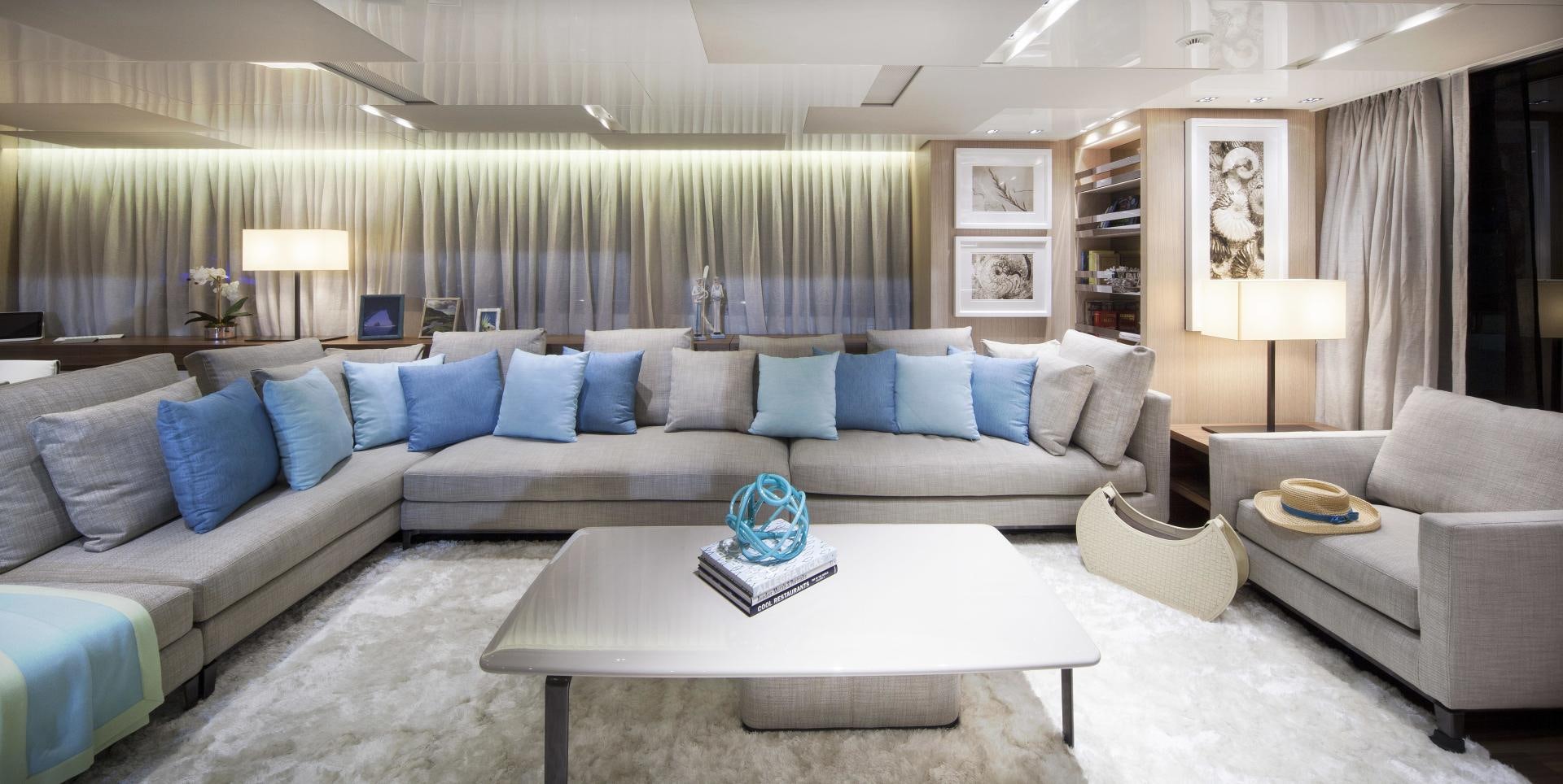a living room with a couch and a coffee table aboard BODACIOUS Yacht for Sale