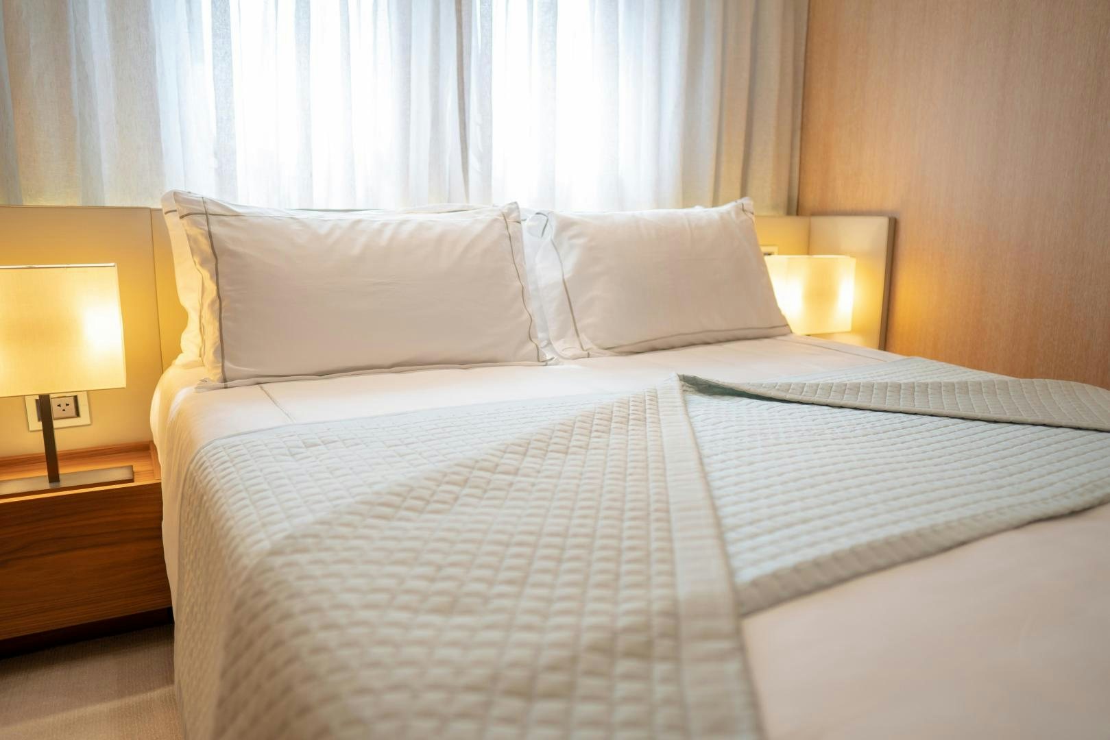 a bed with white sheets aboard BODACIOUS Yacht for Sale