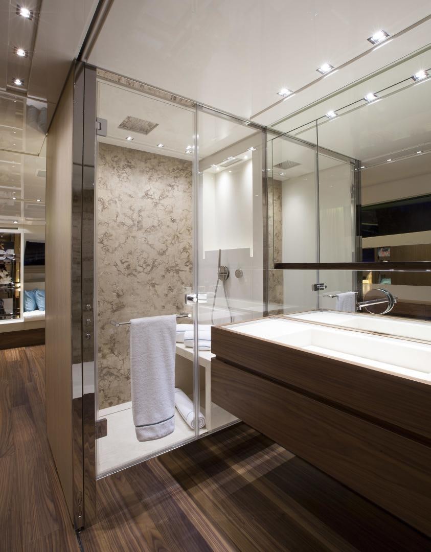 a bathroom with a glass shower aboard BODACIOUS Yacht for Sale