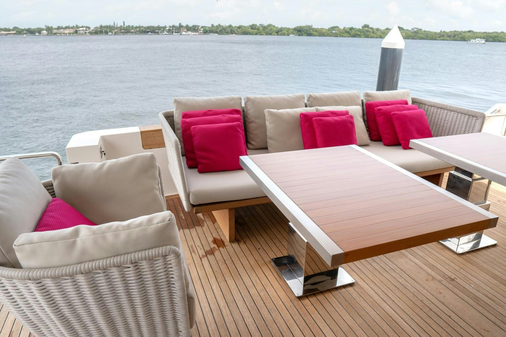 a deck with couches and a table and chairs aboard BODACIOUS Yacht for Sale
