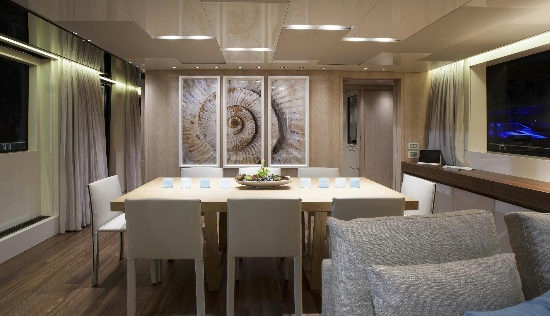 a conference room with a table and chairs aboard BODACIOUS Yacht for Sale