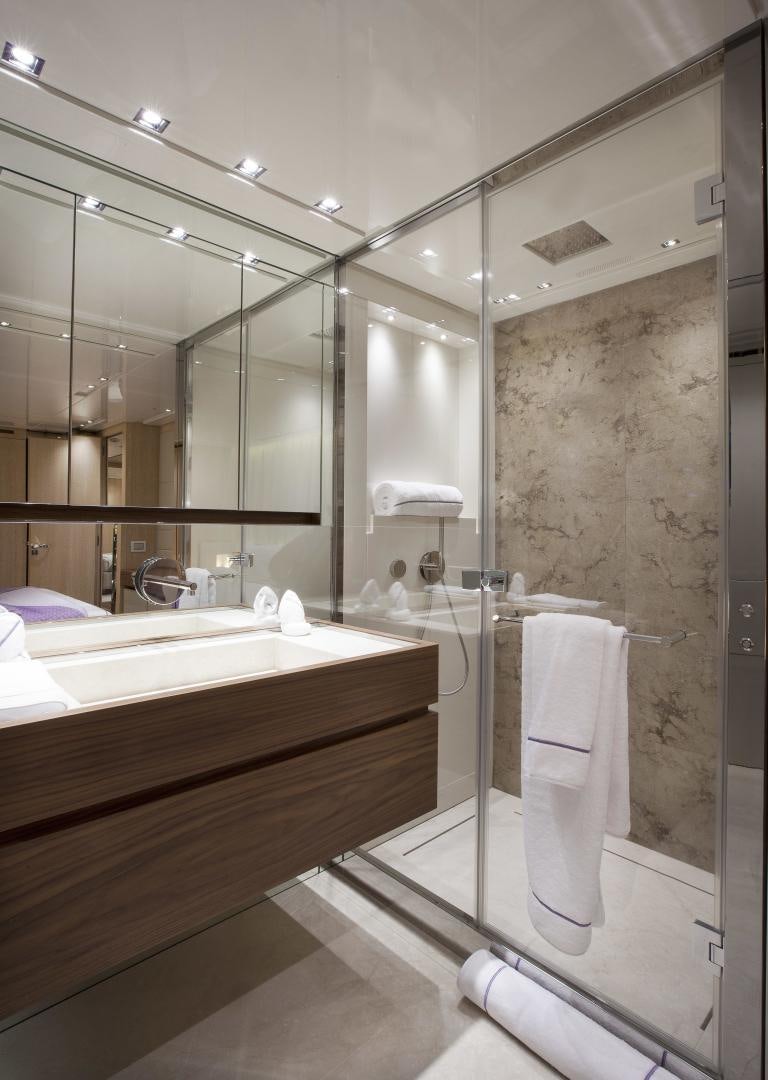 a bathroom with a glass shower aboard BODACIOUS Yacht for Sale