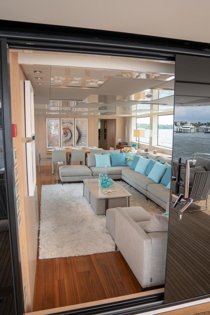 a living room with a couch and a table aboard BODACIOUS Yacht for Sale