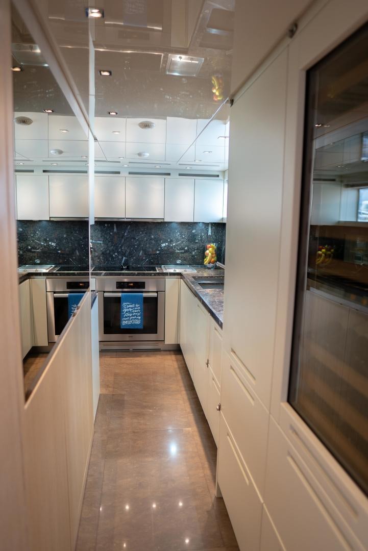 a kitchen with a large glass wall aboard BODACIOUS Yacht for Sale