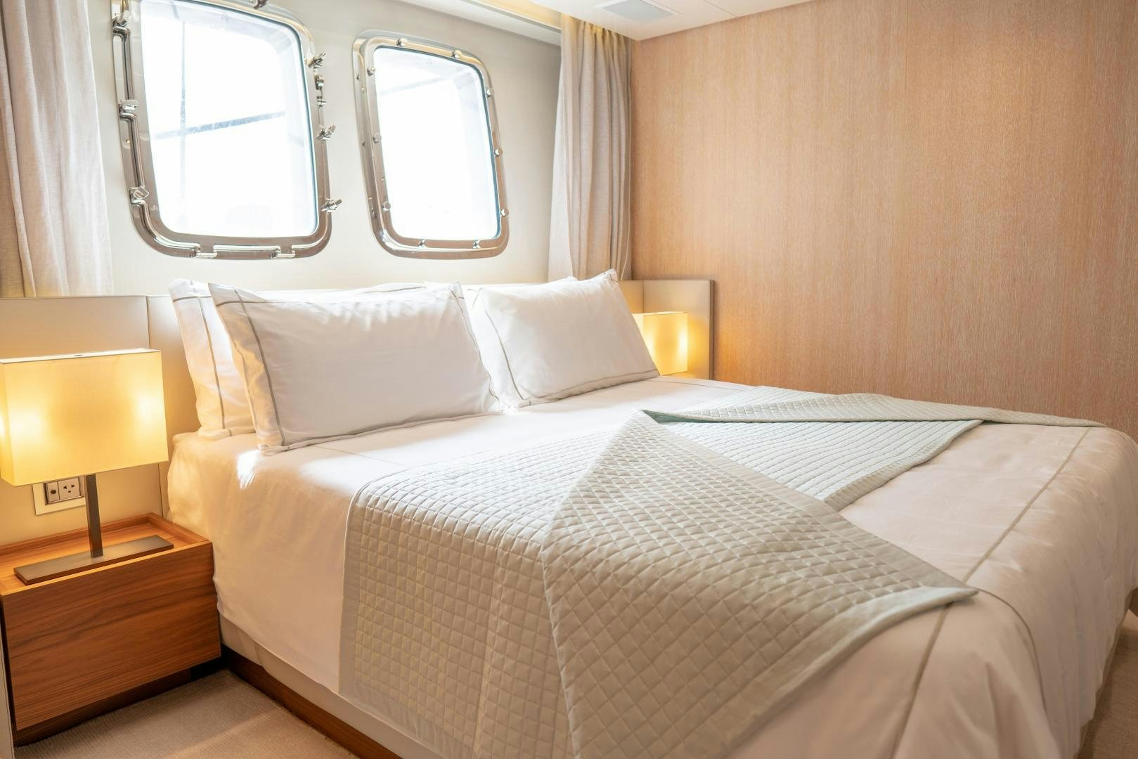 a bed with white sheets and pillows aboard BODACIOUS Yacht for Sale