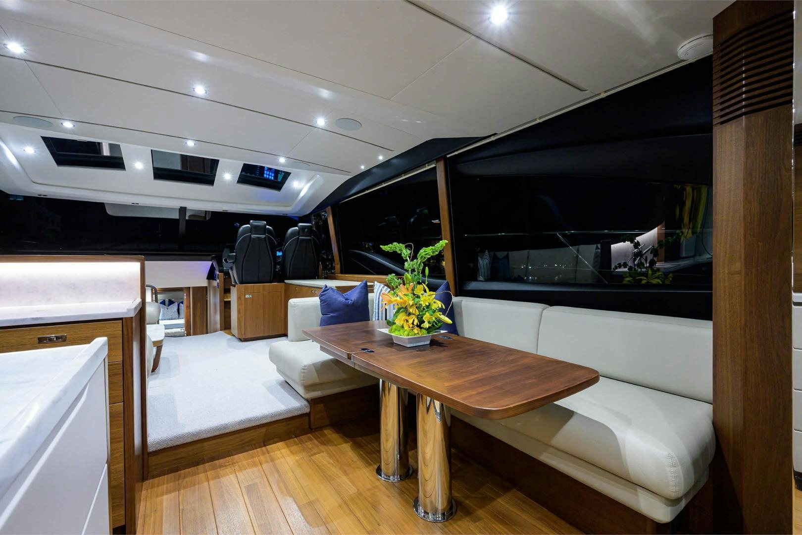 a room with a table and a couch aboard GREAT NEWS Yacht for Sale