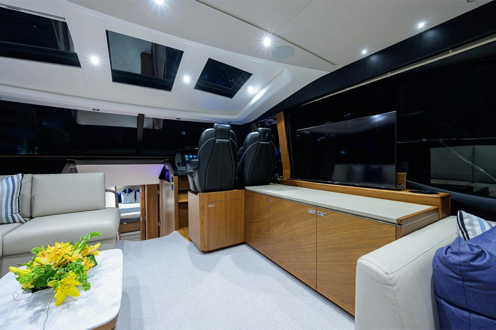 a room with a tv and furniture aboard GREAT NEWS Yacht for Sale