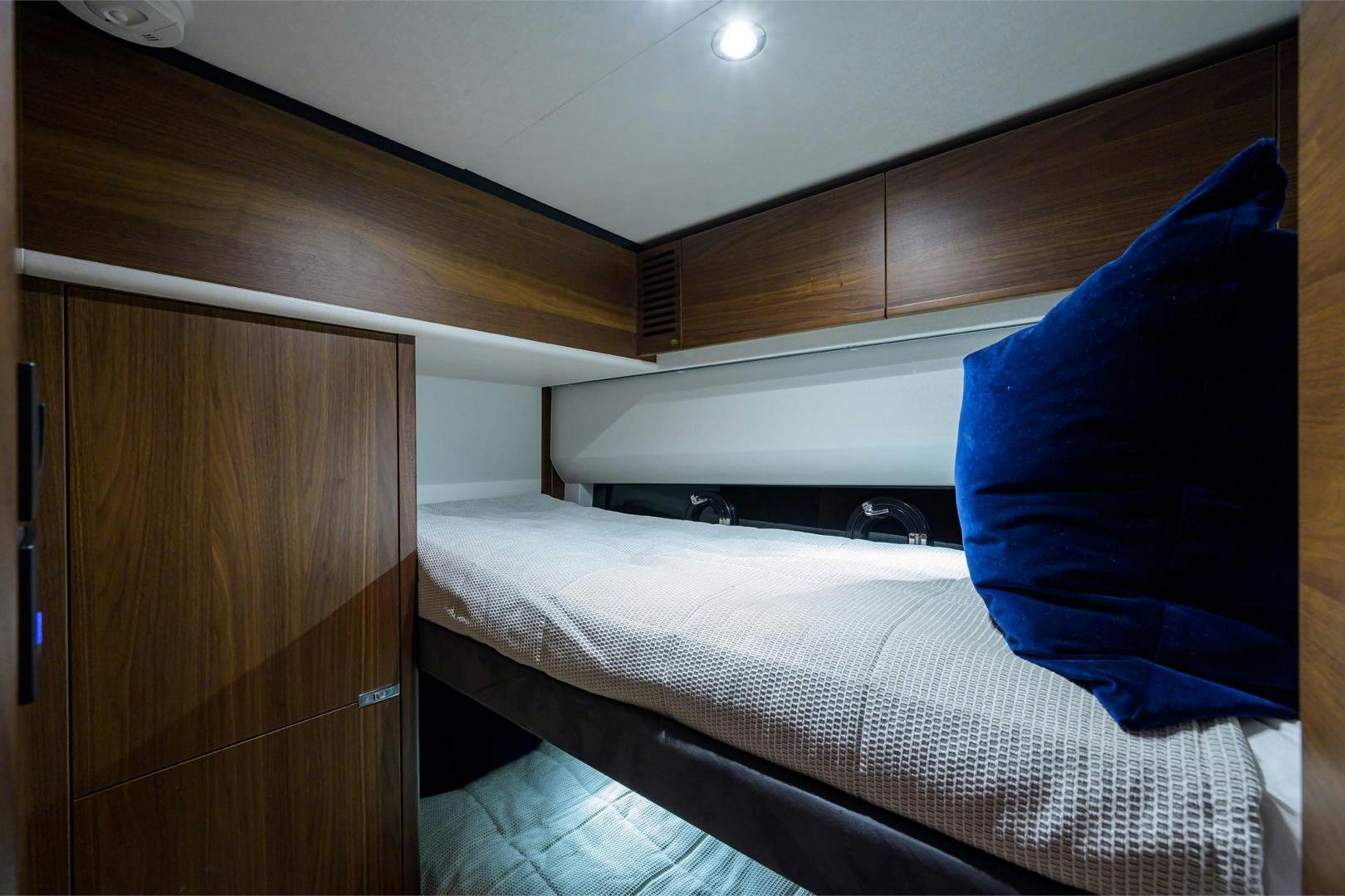 a bed with a blue pillow aboard GREAT NEWS Yacht for Sale
