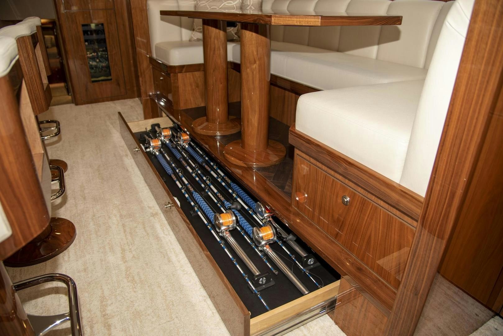 a wooden table with a bar and a stool aboard TAG TEAM Yacht for Sale