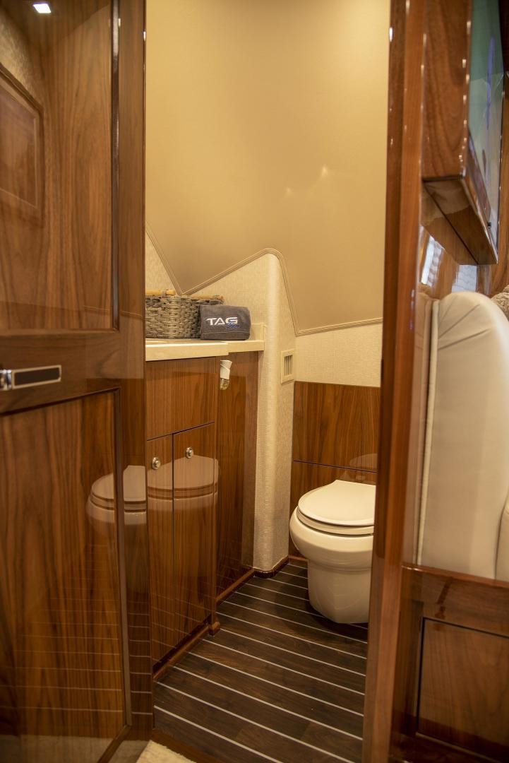 a bathroom with a toilet and a sink aboard TAG TEAM Yacht for Sale