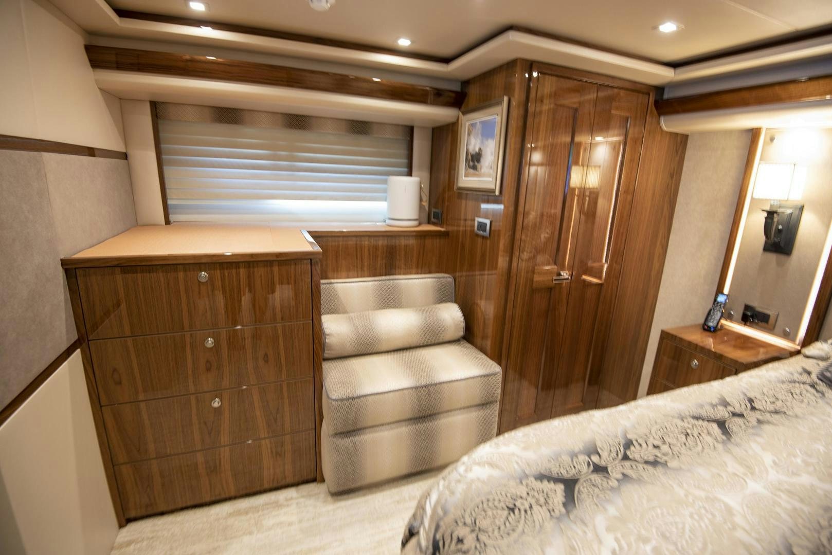 a room with a bed and a chair aboard TAG TEAM Yacht for Sale