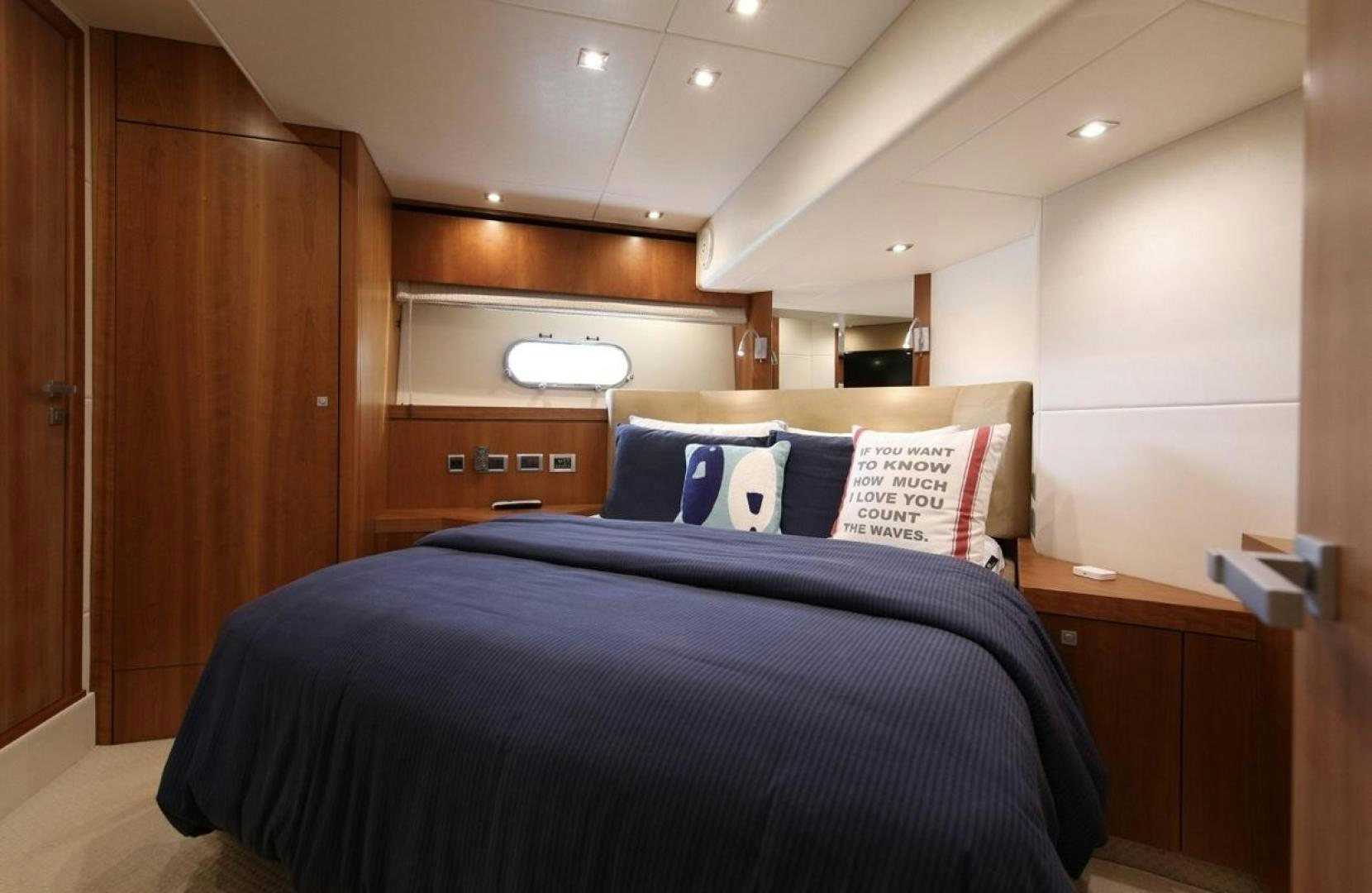 a bedroom with a bed and a desk aboard SEA C Yacht for Sale