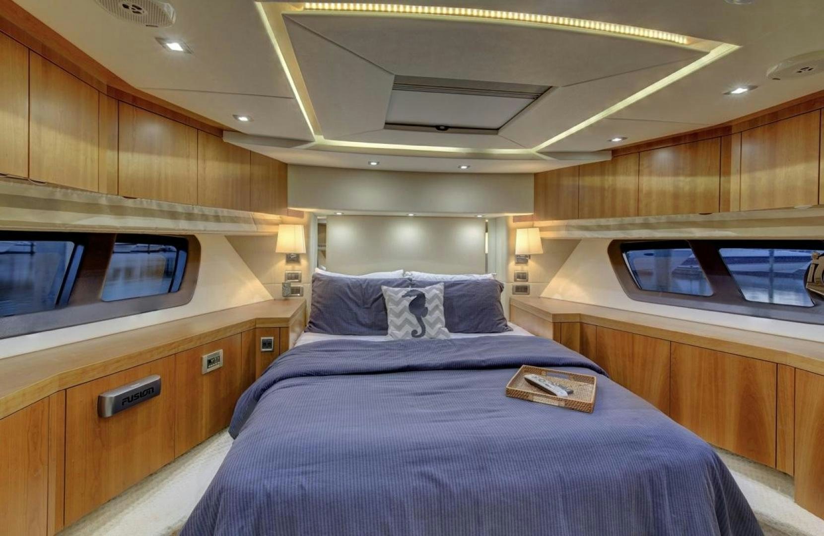 a room with a bed and a television aboard SEA C Yacht for Sale