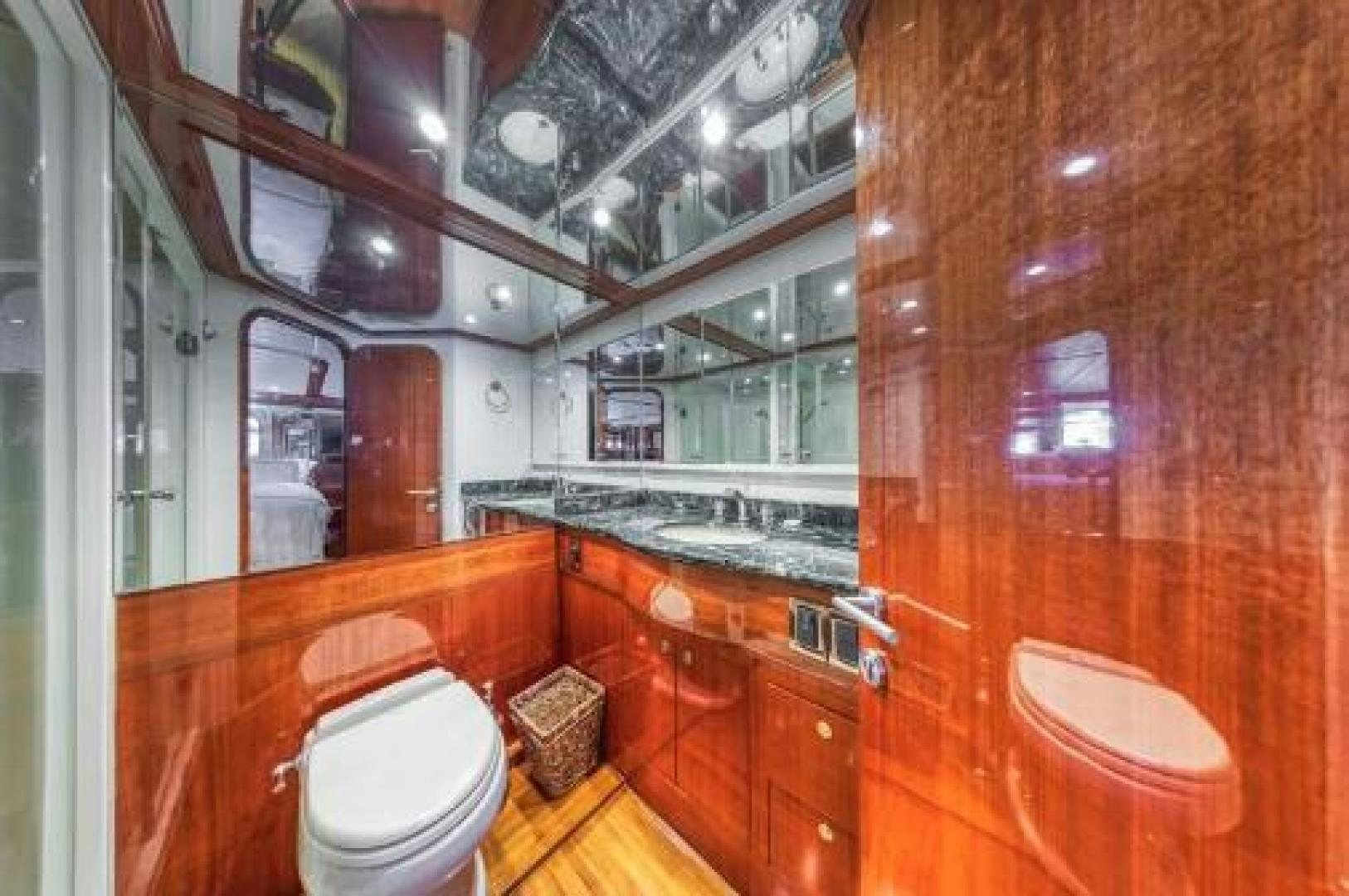 a bathroom with a toilet and a sink aboard JOHNSON 70' FLYBRIDGE M/Y Yacht for Sale