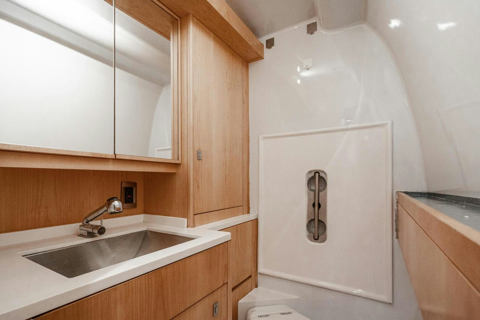 a bathroom with a sink and cabinets aboard MY CAT Yacht for Sale