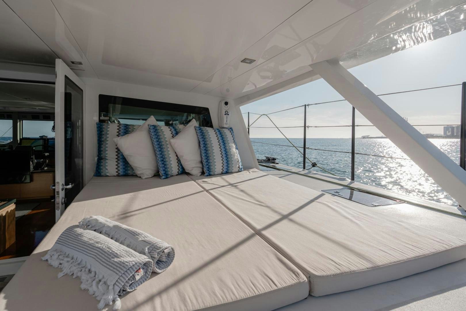a bed with pillows on it aboard MY CAT Yacht for Sale