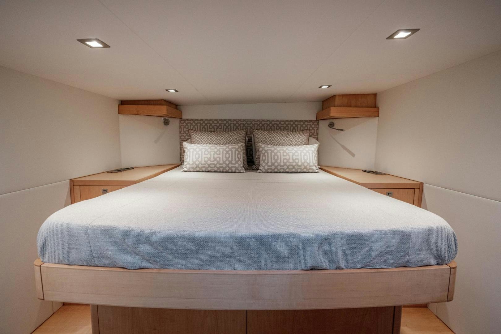 a bed with a blue sheet aboard MY CAT Yacht for Sale