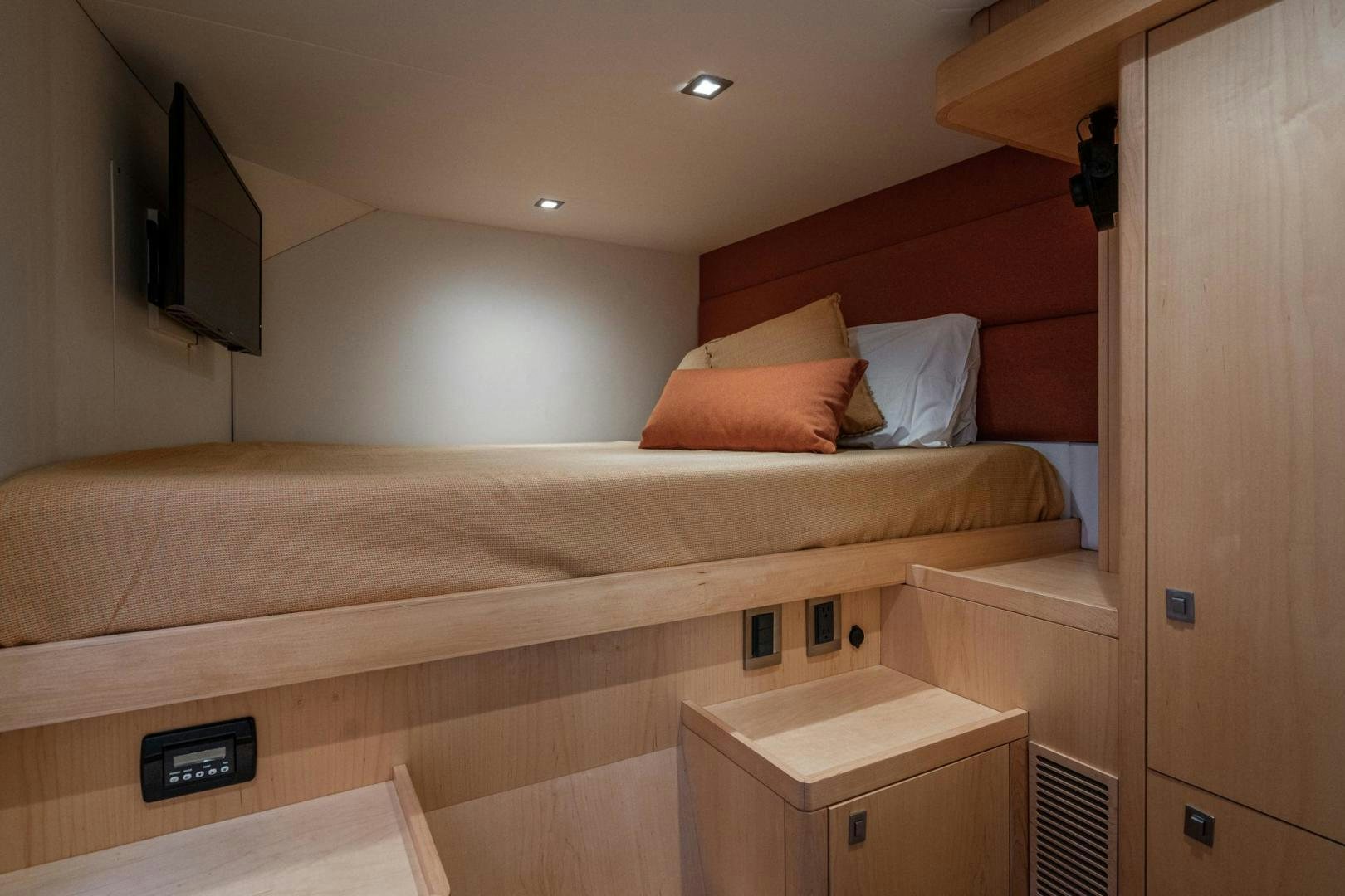 a bed with a tv on top aboard MY CAT Yacht for Sale