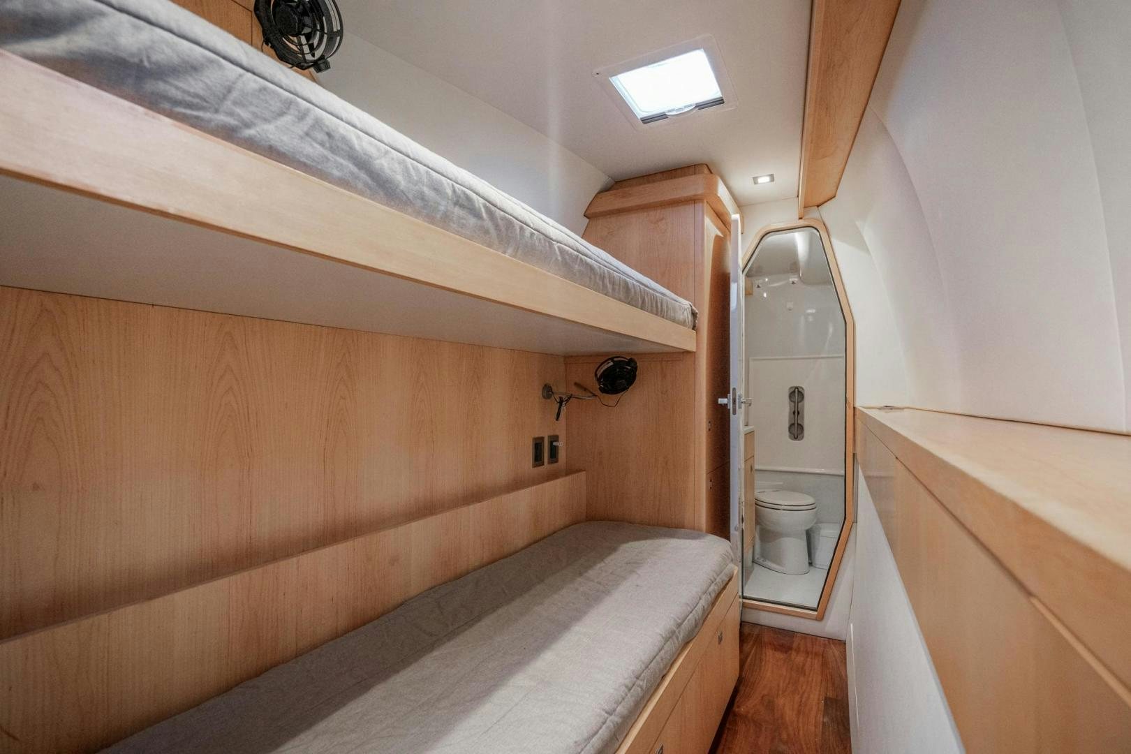 a bathroom with a toilet and a wooden cabinet aboard MY CAT Yacht for Sale