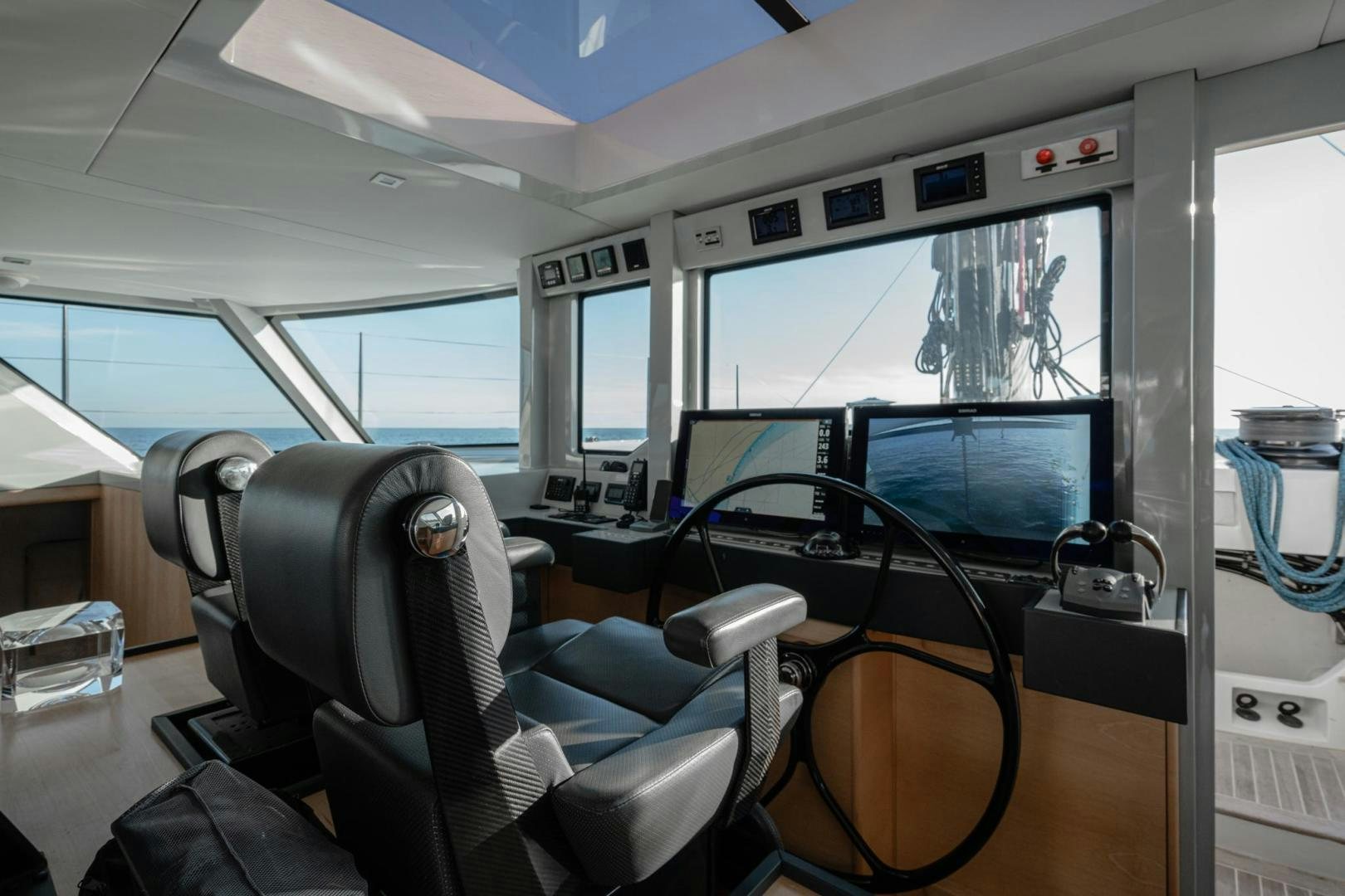inside of a vehicle with a screen and a laptop on the seat aboard MY CAT Yacht for Sale