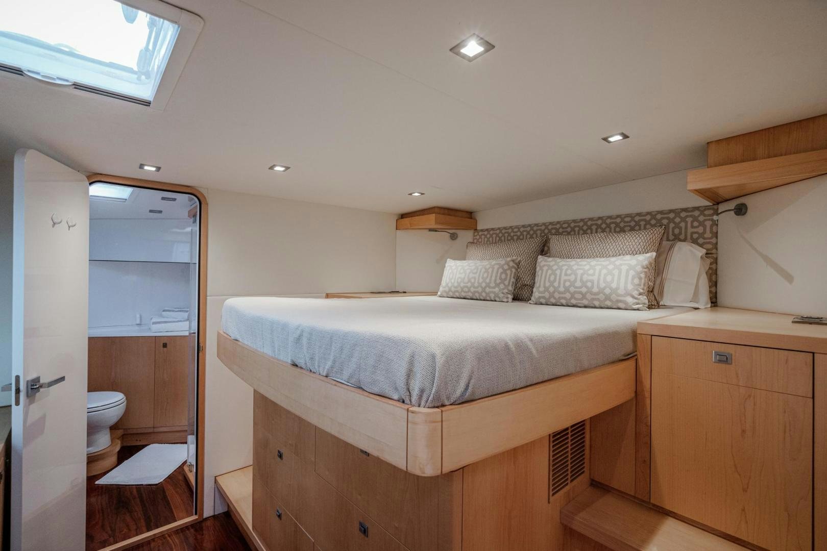 a bedroom with a bed and a mirror aboard MY CAT Yacht for Sale