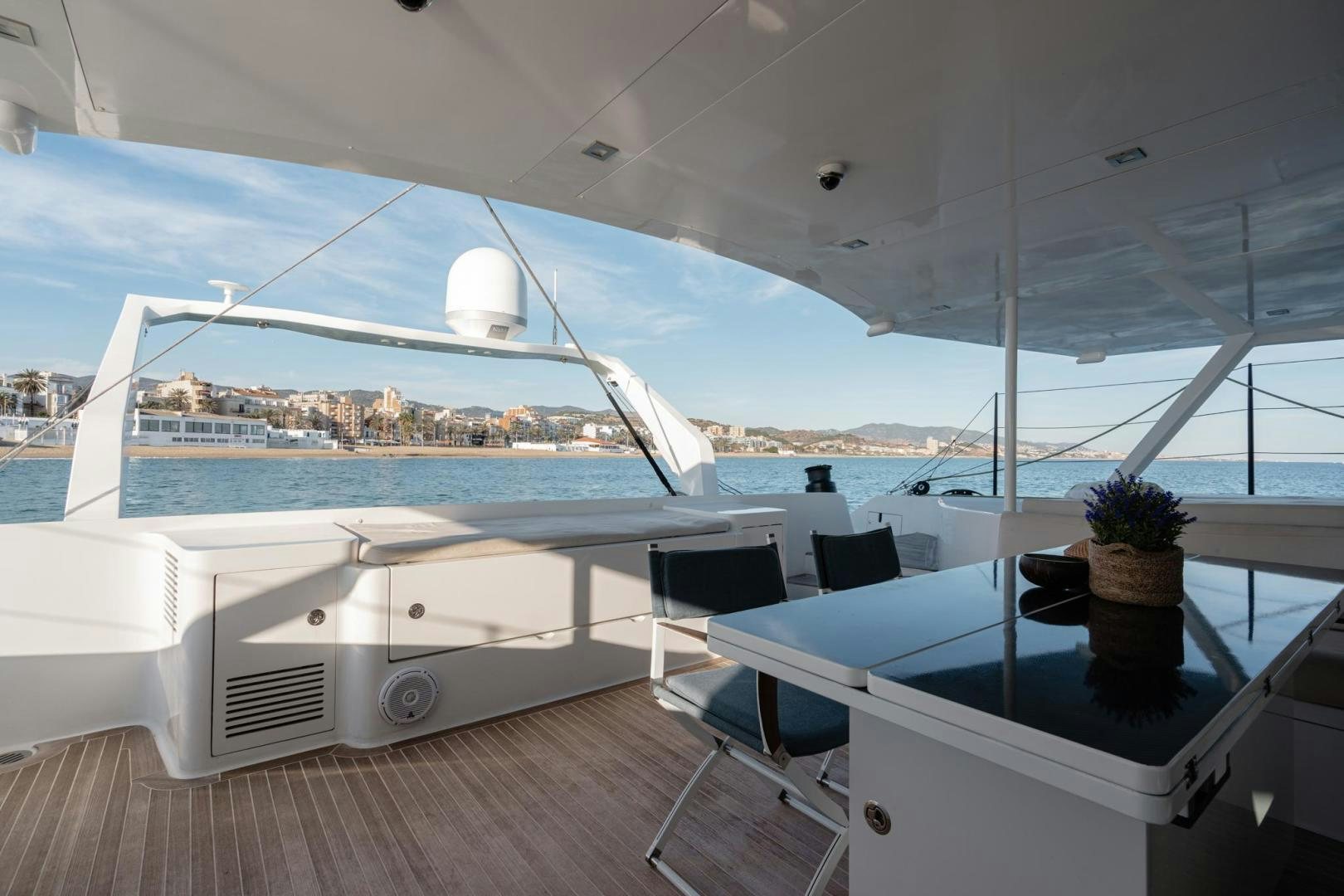 a large white yacht with a large white ship in the background aboard MY CAT Yacht for Sale