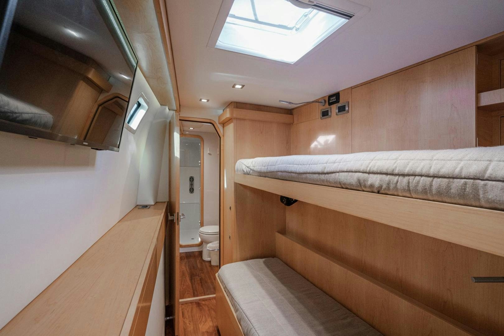 a room with a bed and a desk aboard MY CAT Yacht for Sale