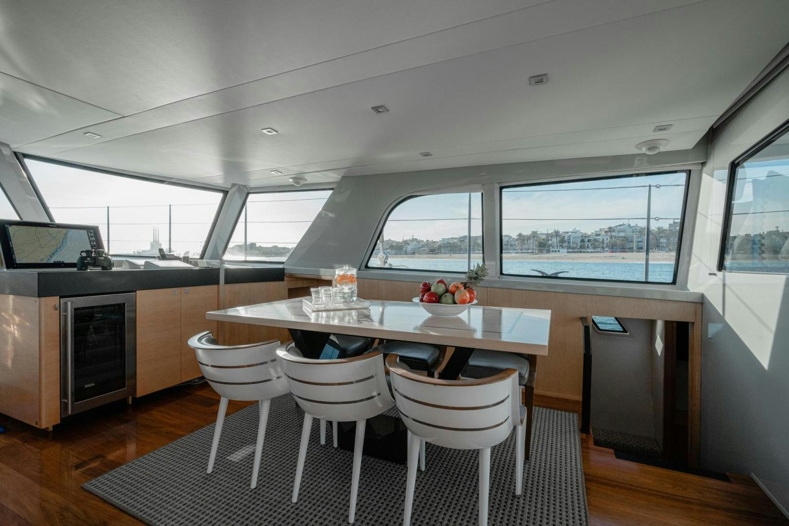 a room with a table and chairs aboard MY CAT Yacht for Sale