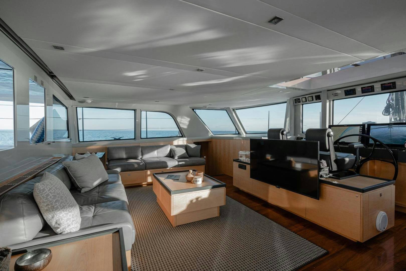 inside of a vehicle with a couch and a piano aboard MY CAT Yacht for Sale