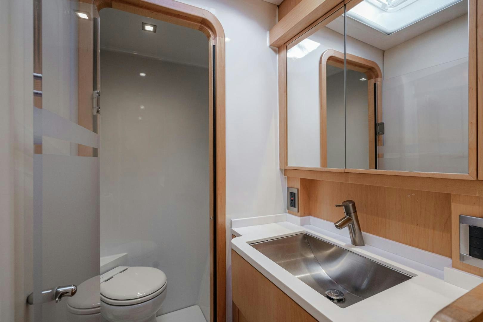 a bathroom with a sink and a mirror aboard MY CAT Yacht for Sale