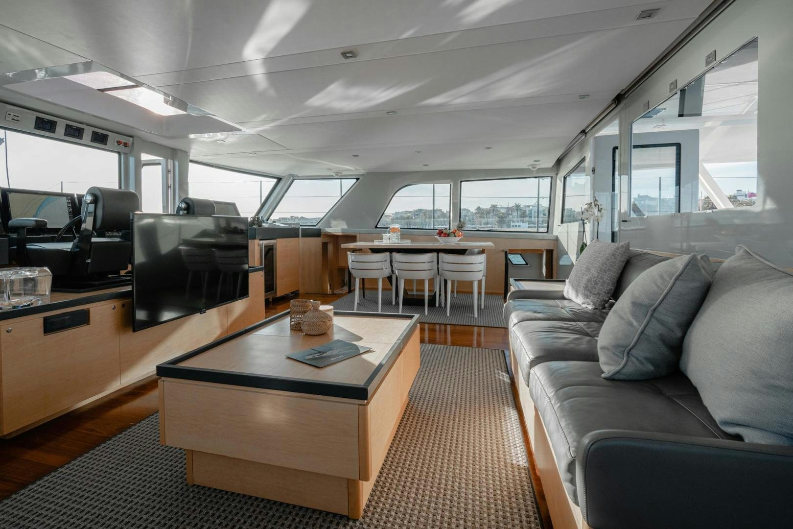 a room with a couch and a table aboard MY CAT Yacht for Sale