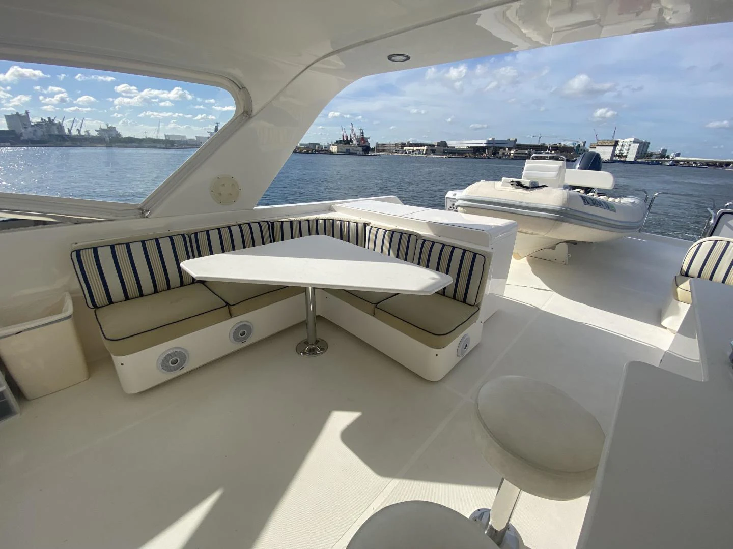 a group of white pianos on a table in a room with a view of water and boats aboard SELQET Yacht for Sale