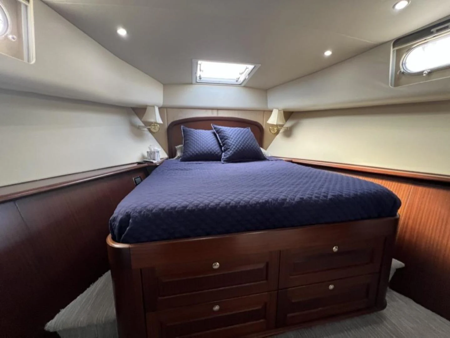 a bed with a blue blanket aboard SELQET Yacht for Sale