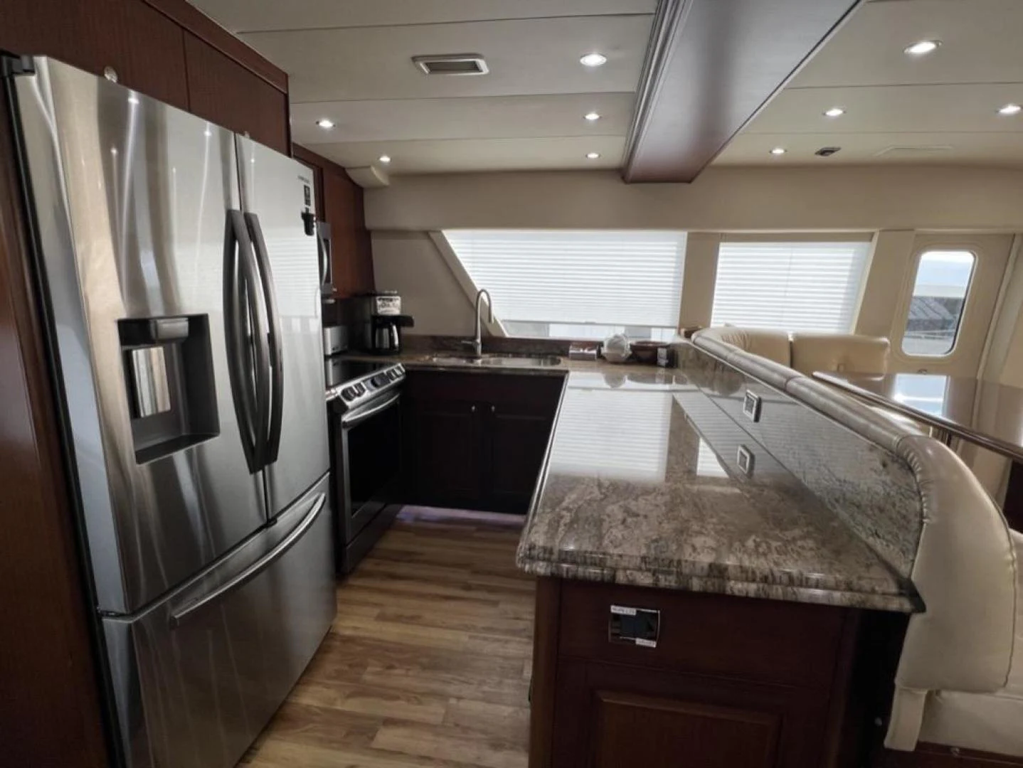 a kitchen with a stainless steel refrigerator aboard SELQET Yacht for Sale