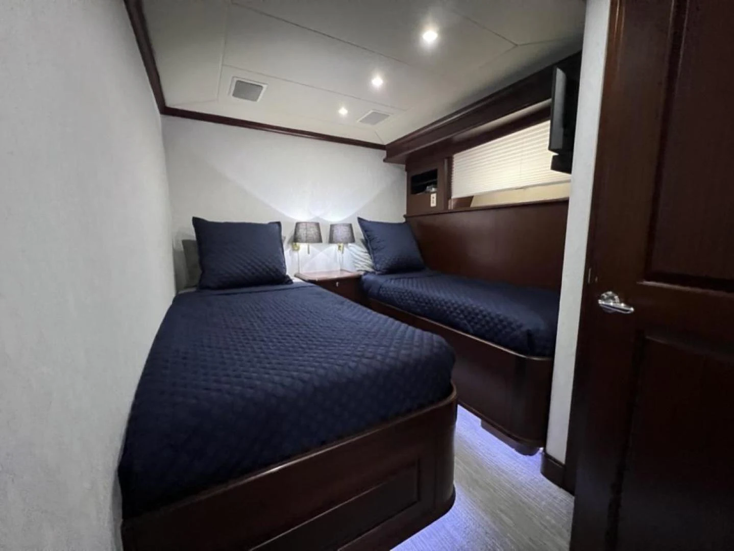 a bedroom with a bed and a couch aboard SELQET Yacht for Sale
