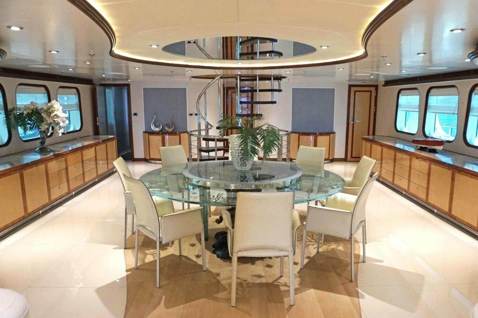 a large room with a table and chairs aboard SOJO Yacht for Sale
