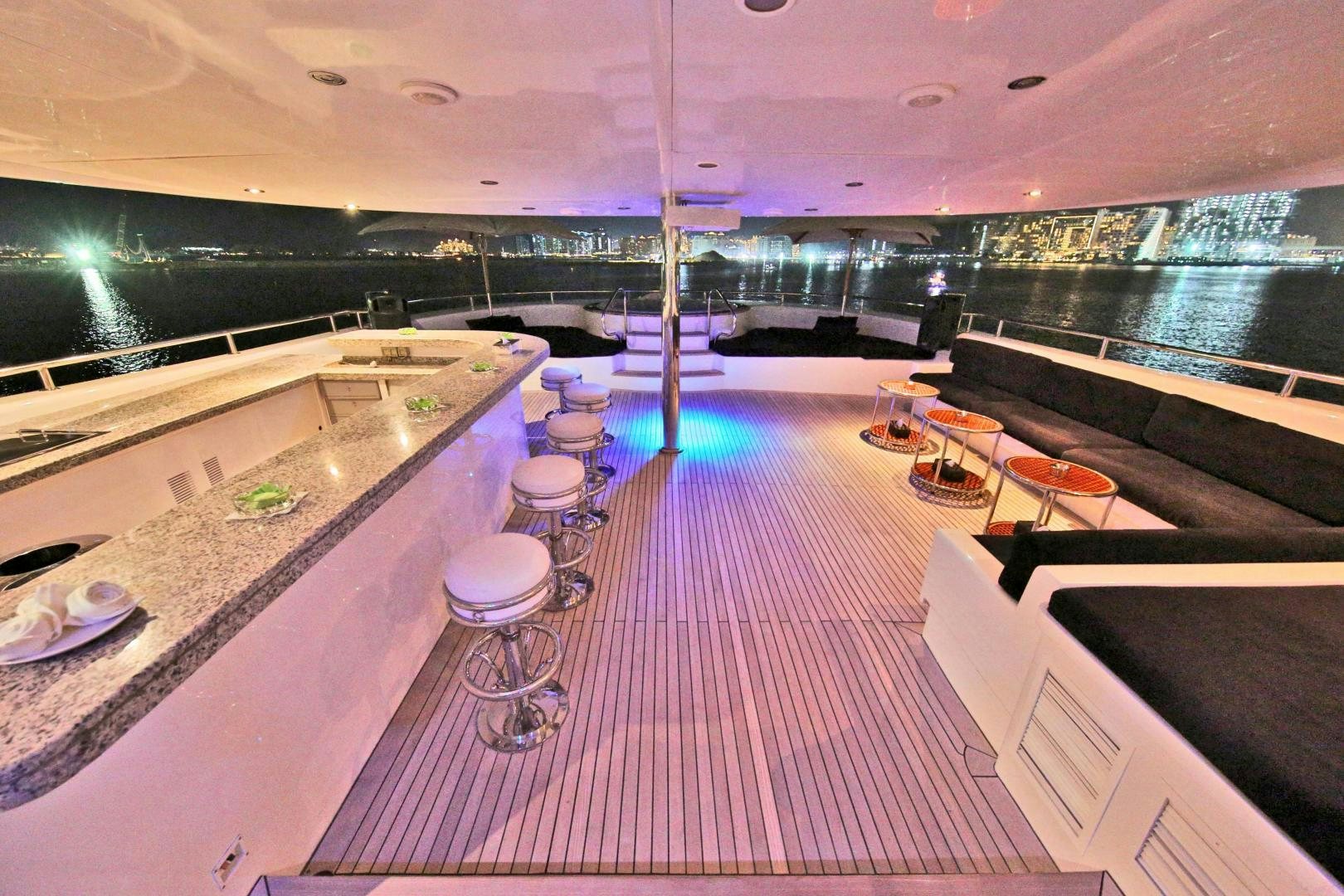 a room with a table and chairs aboard SOJO Yacht for Sale