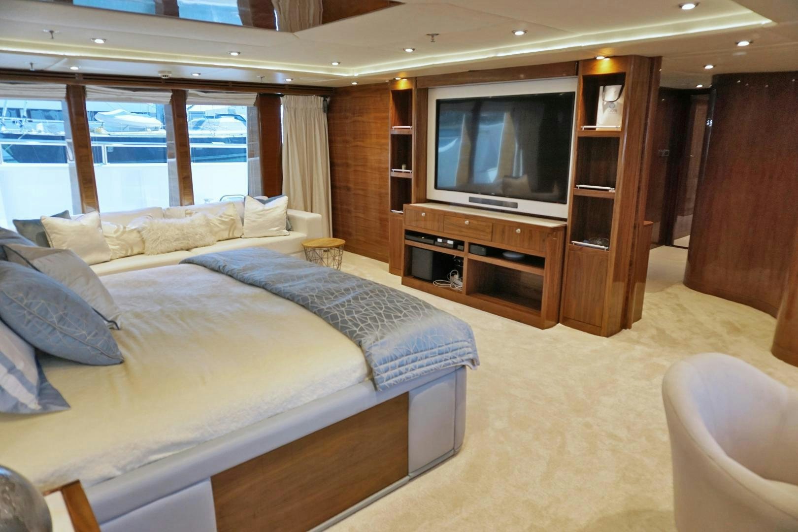 a hotel room with a bed and tv aboard SOJO Yacht for Sale