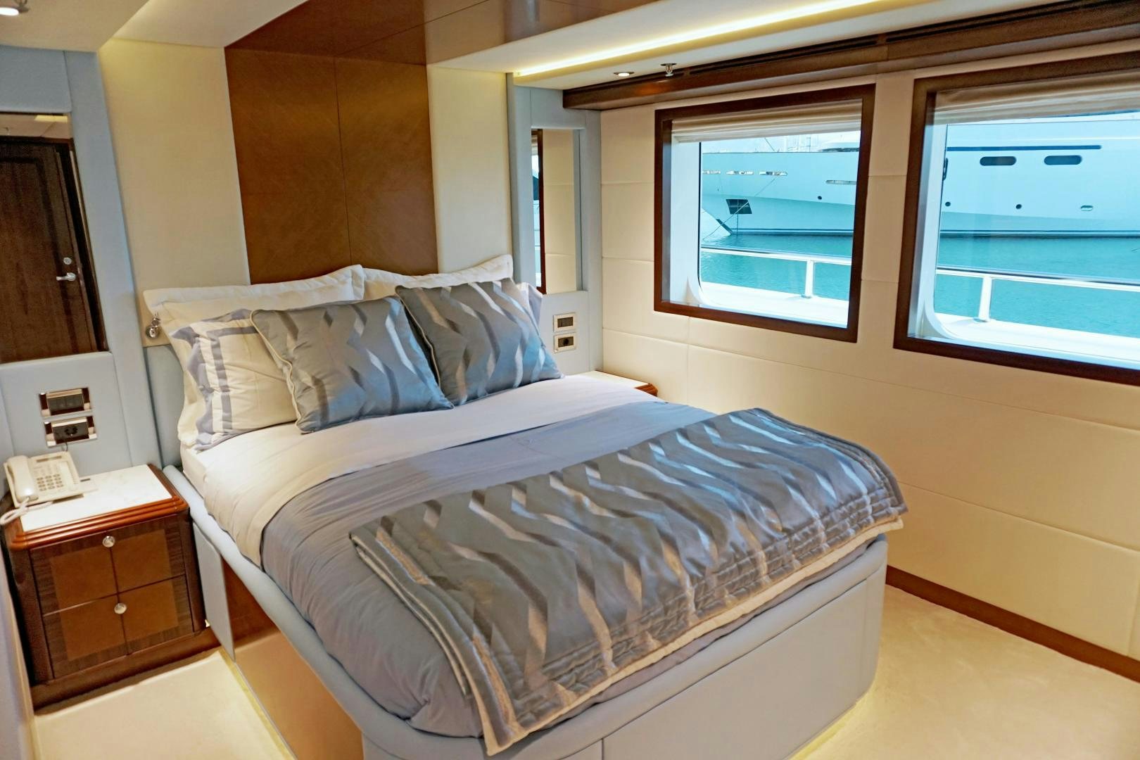 a bed with white sheets aboard SOJO Yacht for Sale