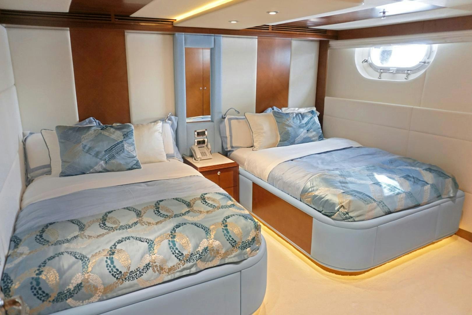 a couple of beds in a hotel room aboard SOJO Yacht for Sale