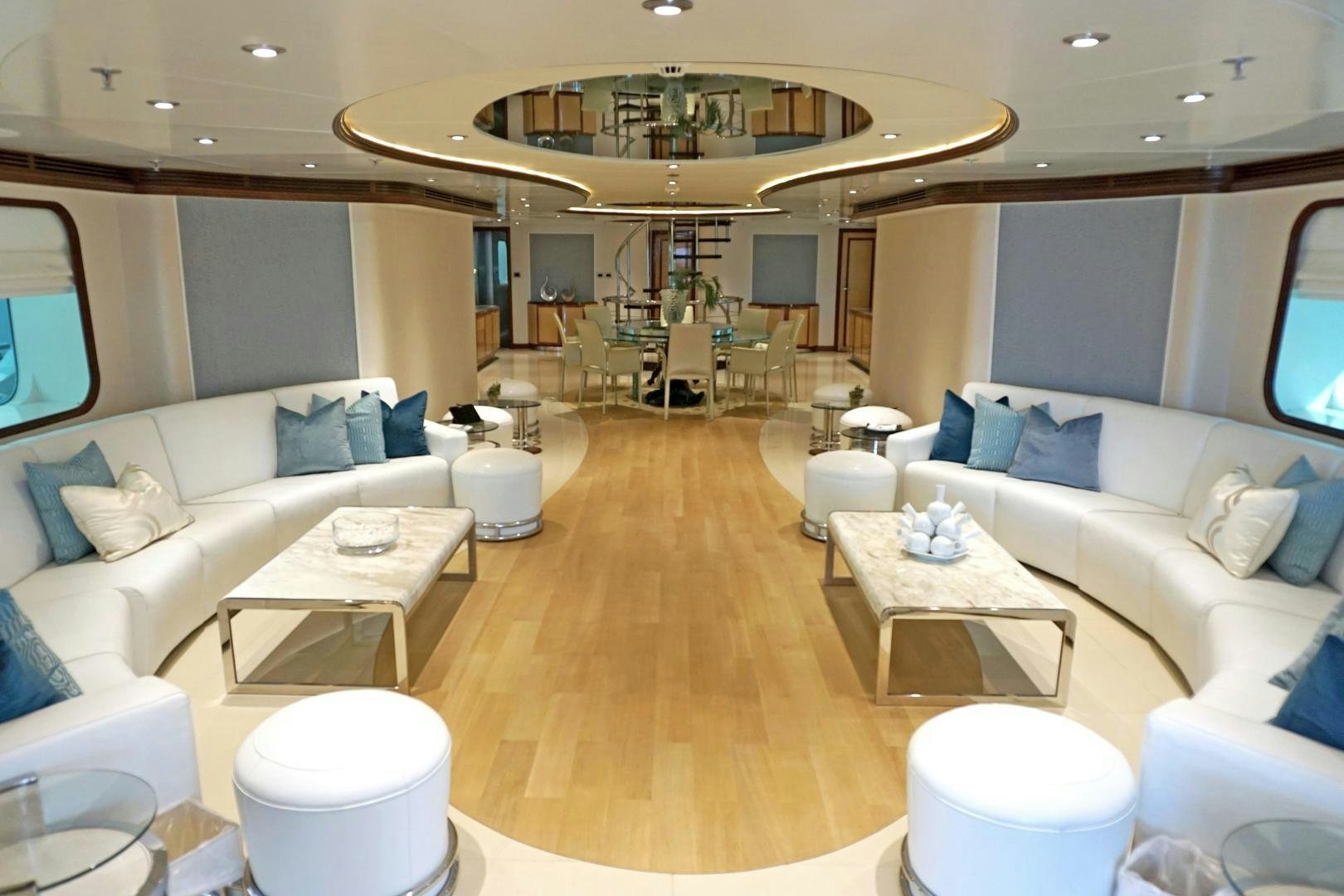 a large room with a large chandelier and a table aboard SOJO Yacht for Sale