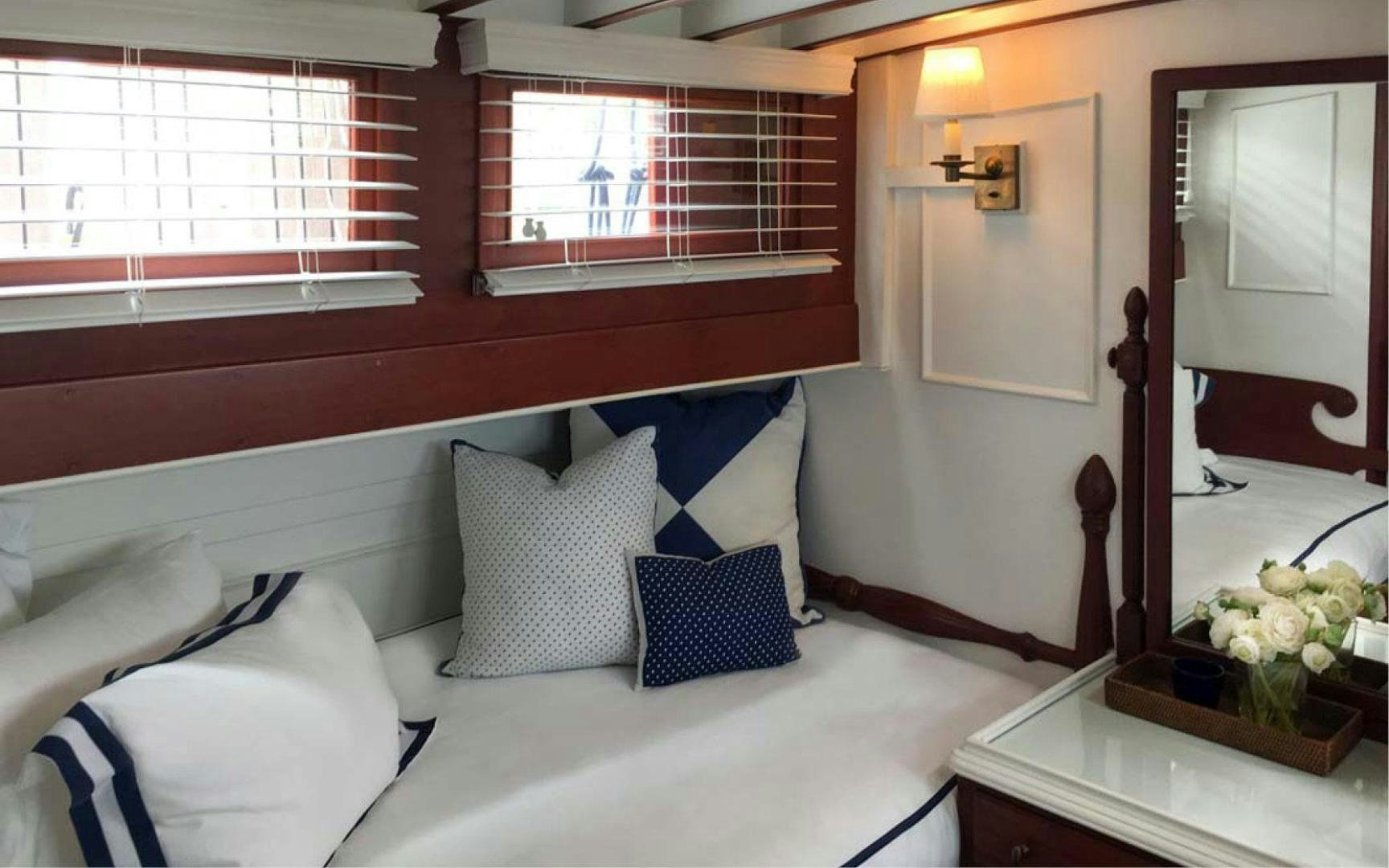 a bed with white sheets and pillows aboard SCOUT Yacht for Sale