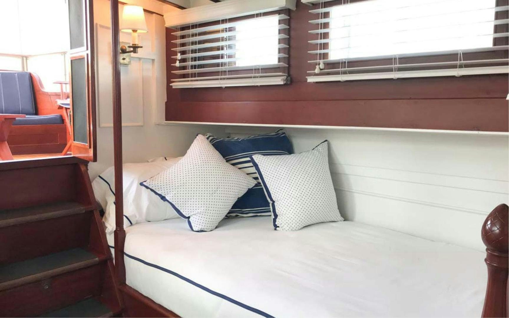 a bed with pillows aboard SCOUT Yacht for Sale