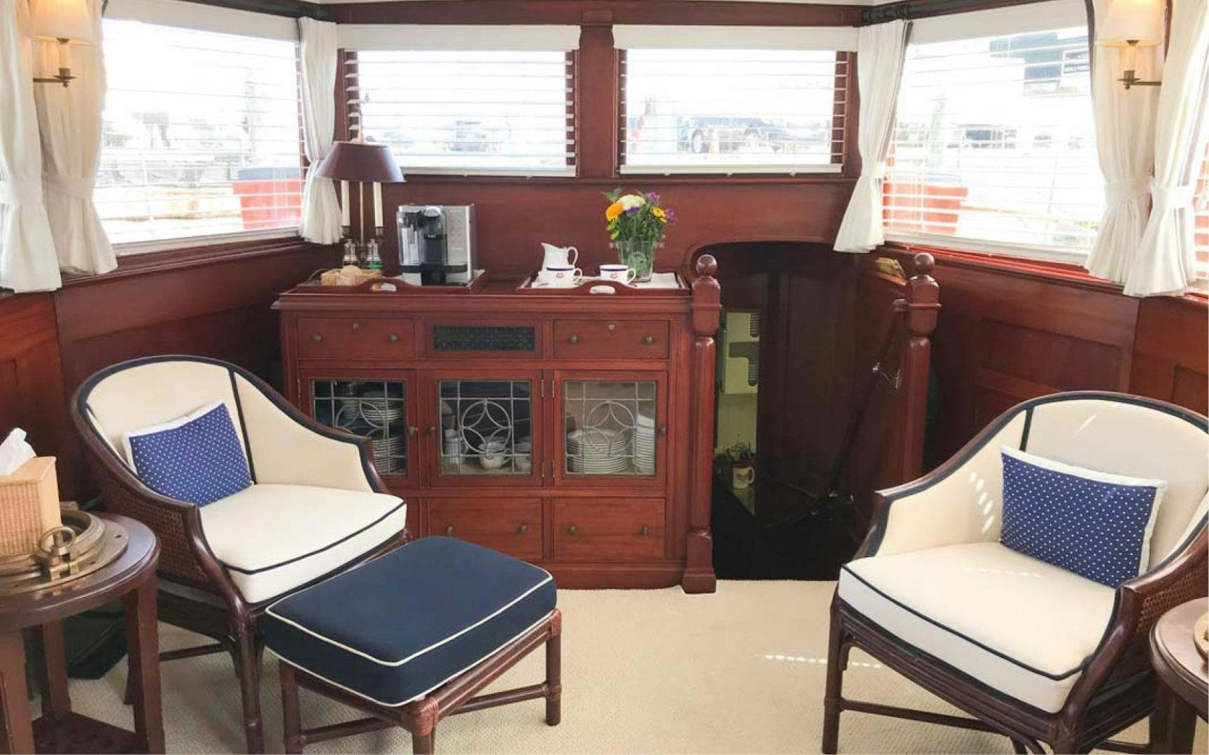 a room with a chair and a dresser and a window aboard SCOUT Yacht for Sale
