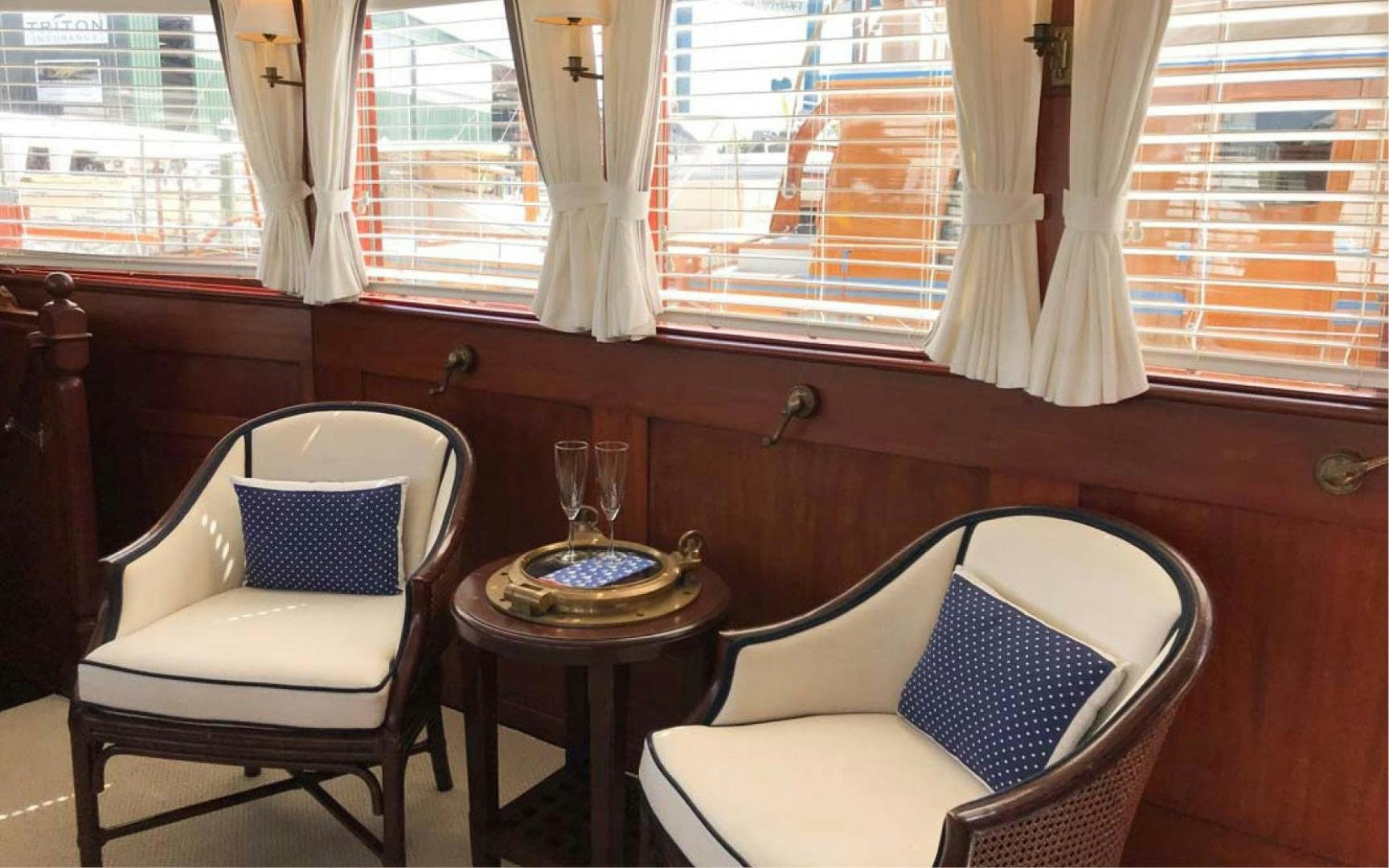 a room with chairs and a table aboard SCOUT Yacht for Sale
