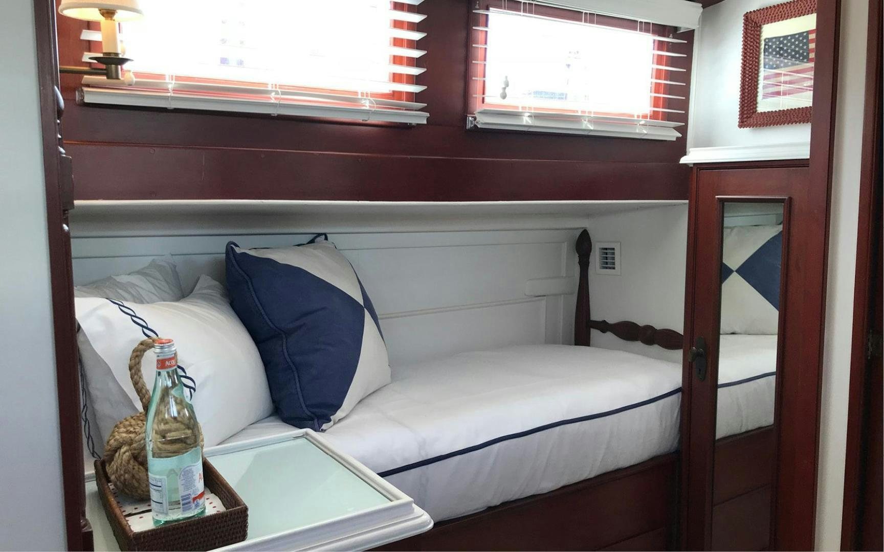 a bottle of beer on a bed aboard SCOUT Yacht for Sale